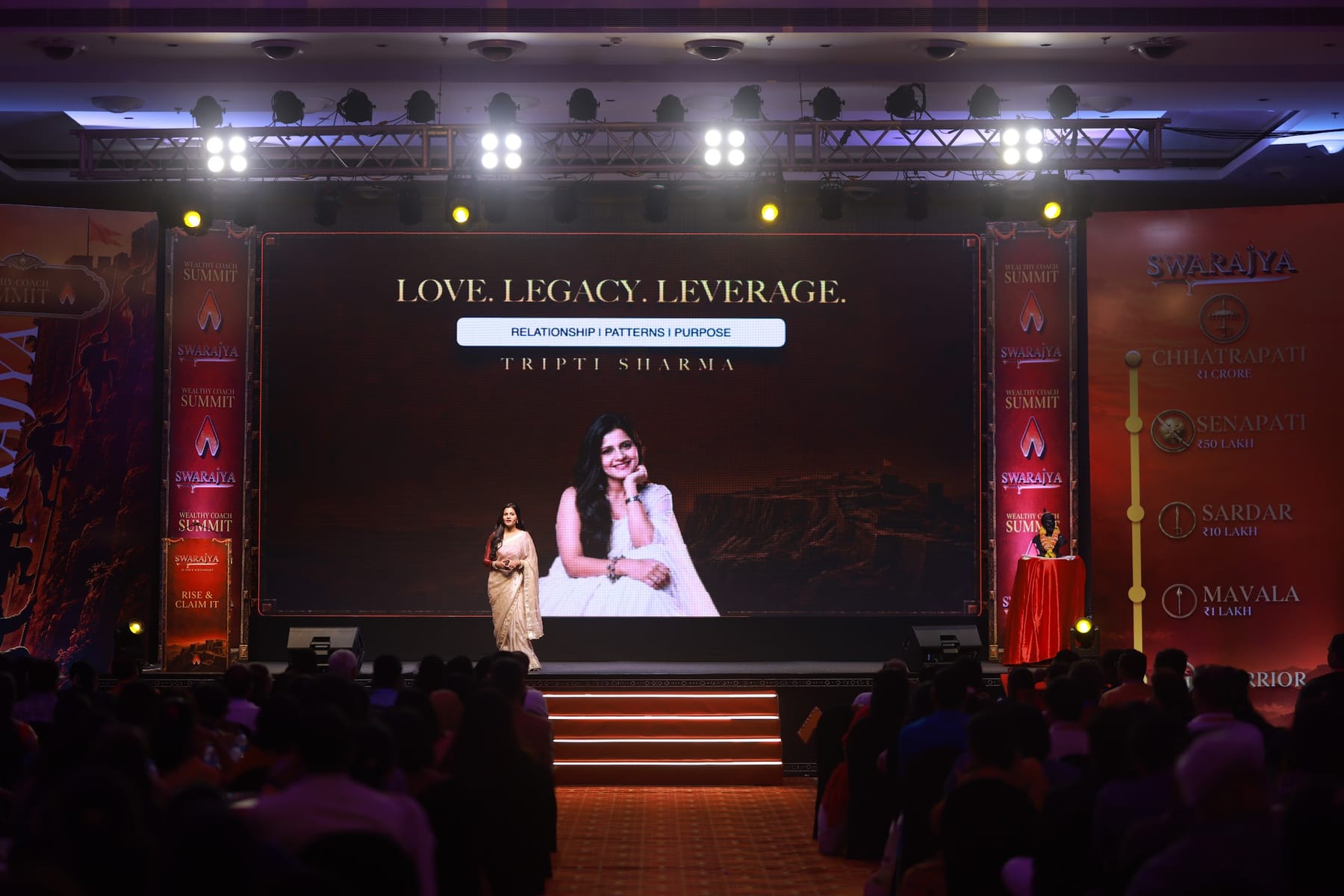 Tripti Sharma delivering a keynote on a large stage
