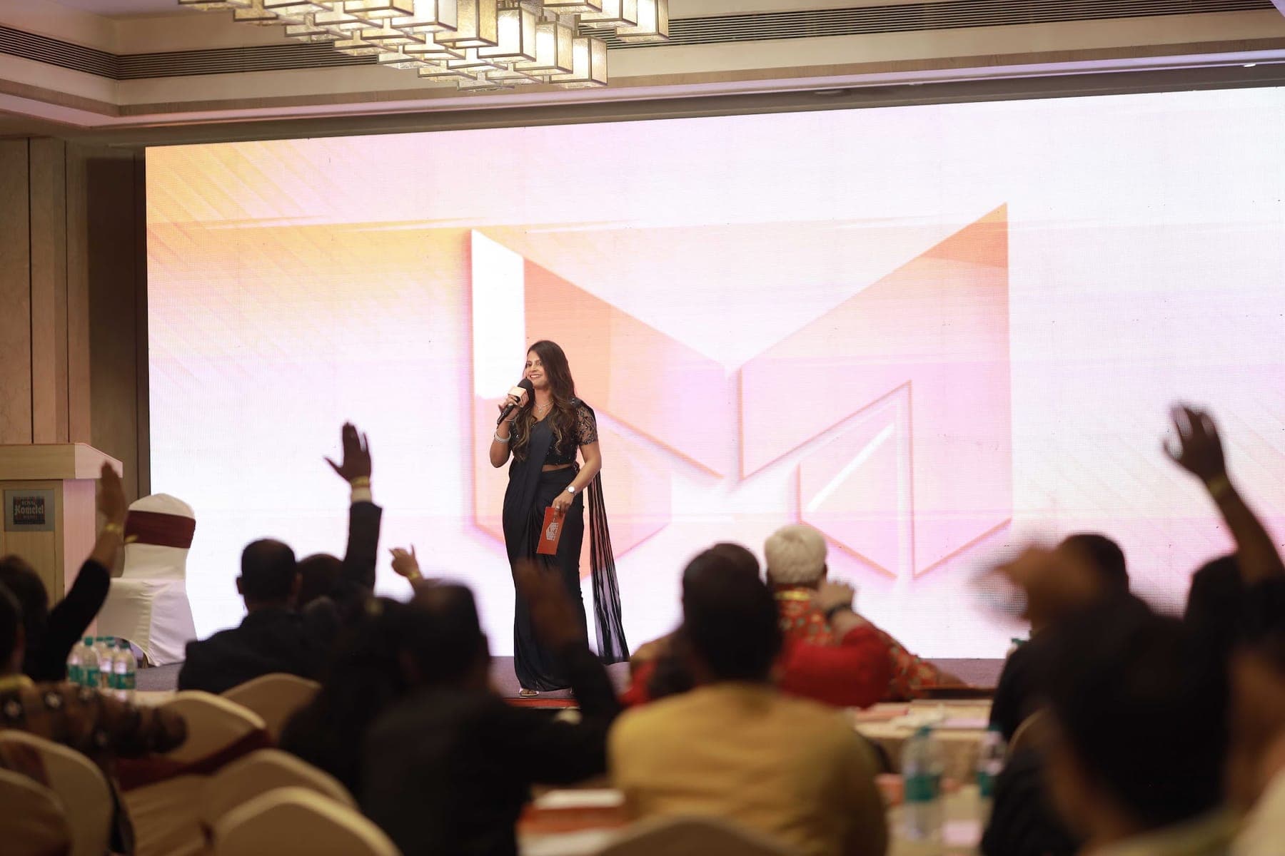 An audience raising hands during Tripti's session