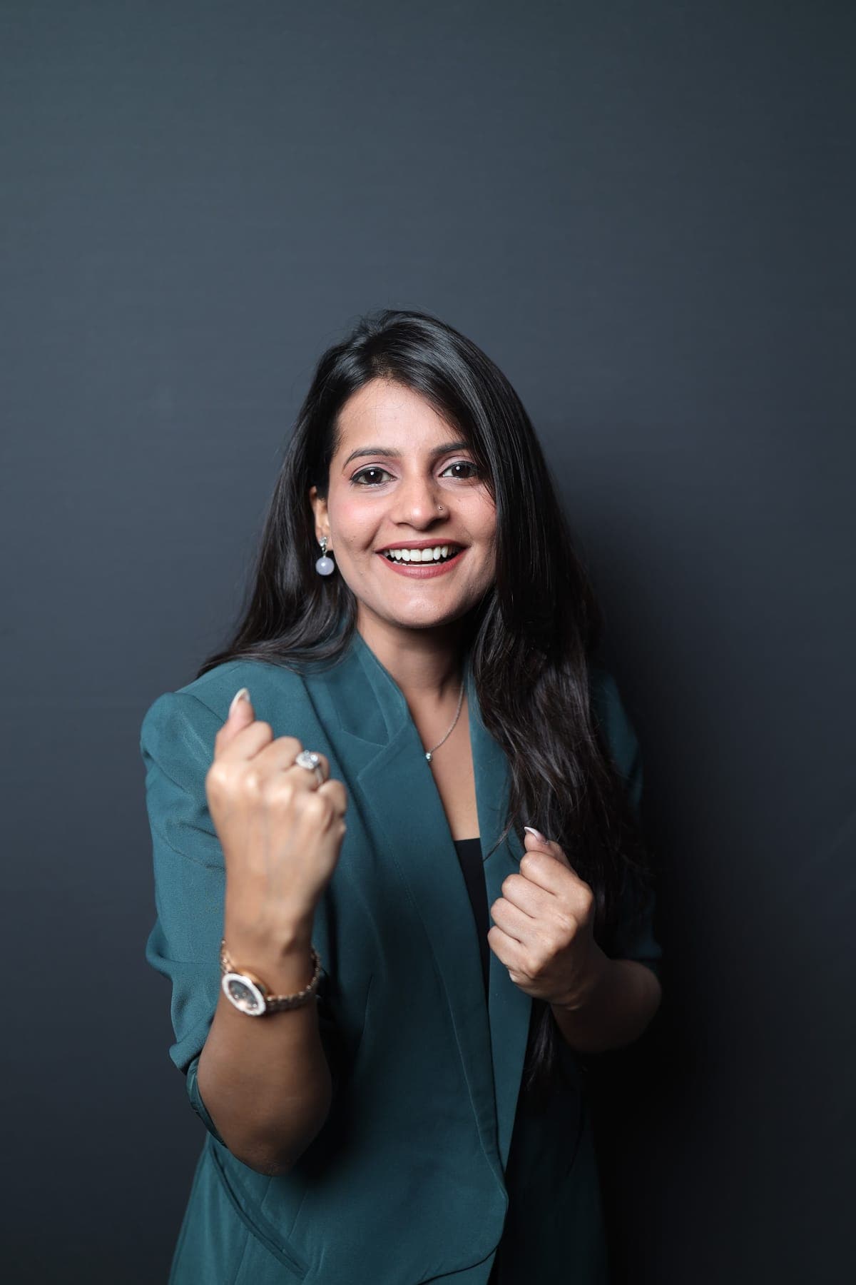Tripti Sharma smiling with both fists raised in celebration